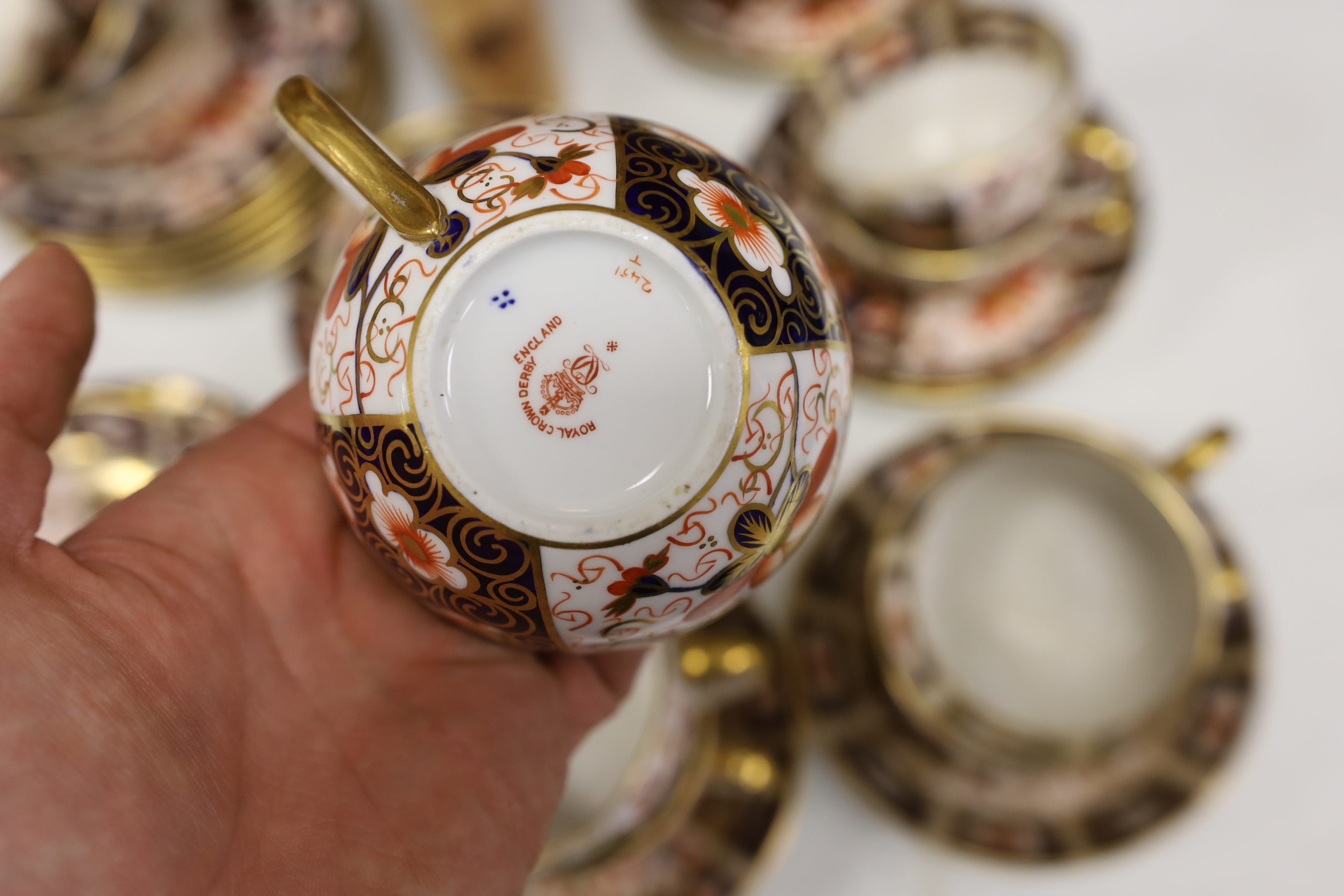 A Royal Crown Derby Imari pattern 2451 part tea set together with an Imari style jug, teapot and stand, largest 18cm high